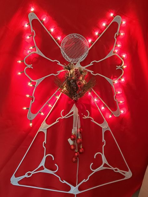 Hanger crafts seem to be all the rage this year! Here is my version of a festive Christmas Angel made with Dollar Tree items. It's easy to make and can be used indoors and out! Star Made From Hangers, Plastic Coat Hanger Angel, Angel Hanger Craft, Clothes Hanger Angel, Plastic Hanger Star Diy, Crafts Made From Plastic Hangers, Angel Christmas Decorations Diy, Clothes Hanger Christmas Decorations, Plastic Coat Hanger Angels