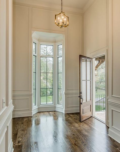 Chic foyer features tall ceilings over full wall wainscoting framing a small bay window | Vintage South Development Colour Hallway, Entrance Modern, Entrance Foyer, Modern Hallway, Tall Ceilings, Narrow Hallway, Hallway Ideas, Decor Minimalist, Wood Flooring