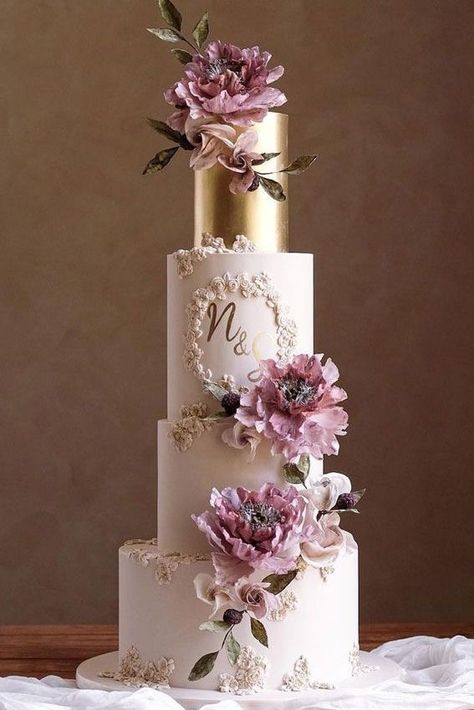 Exuding romance, this wedding cake features layers of white & gold and is topped with purple blooms | wedding, wedding ideas, 2024 wedding trends, wedding inspiration, wedding reception, wedding reception ideas, wedding reception decor, wedding cake ideas, wedding cakes, white wedding cake, luxury wedding cake, romantic wedding, romantic wedding cake, floral wedding cake, white and gold wedding, royal wedding decor, floral cake inspo, winter wedding, winter wedding decor #weddingcakes #wedding Wedding Cake Shapes, Cake Trends 2023, Wedding Cake Trends, Pretty Wedding Cakes, Big Wedding Cakes, Floral Wedding Cake, Luxury Wedding Cake, Dream Wedding Cake, Indian Wedding Cakes