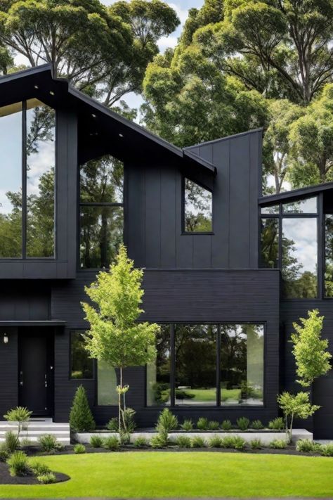 Modern black house with large windows, surrounded by lush greenery and trees. Tiny Modern House Exterior, Dark House Landscaping, Charcoal Home Exterior, Black And Wood House Exterior, Home Exterior Black, Black Contemporary House, Black Exterior House, All Black House Exterior, Black Modern Home