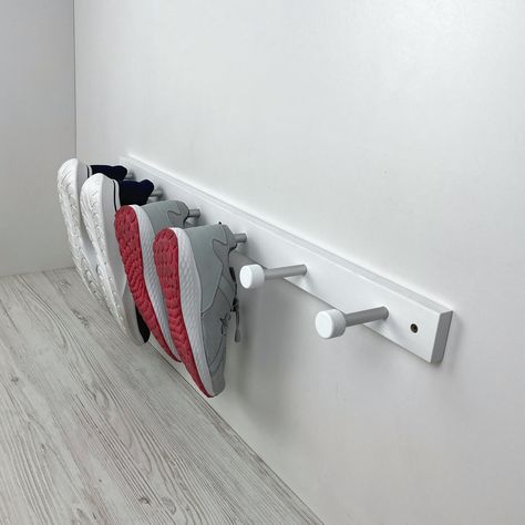 "Free up your entryway with this convenient shoe storage rack. Crafted with wooden board and metal pegs, this white shoe rack for wall will help you store and organize all of your family's shoes quickly and efficiently. No more searching through a mountain of shoes at the door - with this shoe storage solution, you can find what you need instantly! Also Use this shoe storage rack with coat peg rail as a practical wall set for your entryway https://www.etsy.com/listing/1583937369/modern-white-peg-rail-coat-rack-wall?click_key=4194eb9aa402e192ffe1f3f5b0fc2f4d0057fd3e%3A1583937369&click_sum=65e4025a&ref=shop_home_active_1&sts=1 DIMENSIONS: S - for 1 pair of shoes Length: 10 inches (28 cm) Depth: 3 inches (7.5 cm) Height: 2 inches (5 cm) M - for 2 pairs of shoes Length: 20 inches (53 cm) Depth Wall Mount Shoe Rack, Shoe Rack For Wall, Shoe Rack Unit, White Shoe Rack, Wall Shoe Rack, Wall Mounted Shoe Storage, Wall Mounted Shoe Rack, Coat Pegs, Diy Shoe Rack