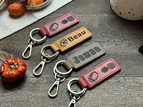 Football Keychain, Football Team Gifts, Football Senior Night Gifts, Personalized Football Gifts, Key Ring, End of Season, Football Banquet for just $12.00 #SeniorNight #KeyRing #FootballBanquet #EndOfSeasonGift #KeychainBoyfriend #FootballTeamGifts #FootballPlayerGift #FootballKeychain #PersonalizedGifts #FootballGifts Football Senior Night Gifts, Personalized Football Gifts, Football Keychain, Football Team Gifts, Football Banquet, Senior Night Gifts, Senior Night, Personalized Football, Custom Football