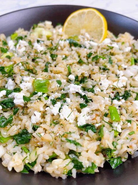 spanakorizo greek spinach rice with lemon and dill in the instant pot hero image close up in black bowl with lemon and feta crumbled. Greek Hummus Recipe, Greek Lentil Soup Recipe, Authentic Tzatziki Sauce Recipe, Rice With Lemon, Greek Lentil Soup, Greek Stuffed Peppers, Dill Rice, Greek Rice, Greek Spinach