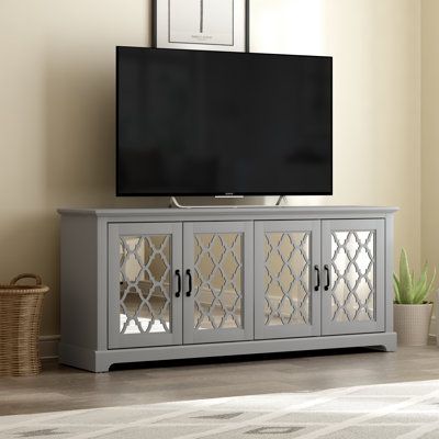 Anchor your living room or entertainment space with this charming TV stand. It crafted from manufactured wood, the mirror doors front design bring a luxe and accent style to this TV stand. You can pull the remove control, TV modem, or any stuffs into 2 spacious cabinets. Plus, it wide surface top offers enough rooms for your TV. This piece can also be used as a stately sidebourd in the your living room Color: Cool Gray | Rosalind Wheeler Abbie-May TV Stand for TVs up to 75 Wood in Gray | Wayfair Rustic Media Console, Wide Tv Stand, Trellis Panels, Farm House Colors, Entertainment Console, Living Room Tv Stand, Tv Stands And Entertainment Centers, Media Console, Grey Oak