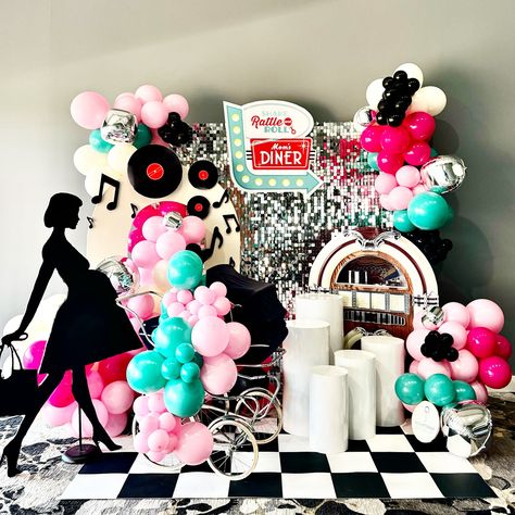 Step back in time with our retro-inspired install at the @operationshower baby shower! 🎶🍽️ We brought a touch of nostalgia with a jukebox, vinyl records, and music notes to complement the celebration for our military moms-to-be. 💕 The setup featured: 🎵 A vibrant jukebox and music notes filling the air with good vibes ✨ A shiny silver shimmer wall that added a touch of glam 🍰 Dessert stands offering sweet treats 👶 A stylish mommy-to-be silhouette cutout 🏁 Classic checker flooring and a playfu... Silver Shimmer Wall, 50s Themed Party, Musical Grease, Shake Rattle And Roll, Themed Centerpieces, Grease Musical, Dessert Stands, Balloon Garland Diy, Shimmer Wall