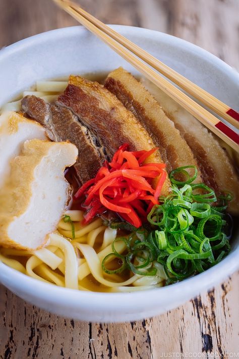 A classic Okinawan dish - Okinawa Soba. Chewy flat noodles, braised pork belly slices, fish cake, green onion, and red pickled ginger in a delicious Japanese dashi and pork broth. #Okinawa #OkinawaSoba #JapaneseFood #AsianFood | Easy Japanese Recipes at JustOneCookbook.com Okinawa Soba Recipe, Okinawa Food, Soba Recipe, Okinawa Diet, Flat Noodles, Asian Soup Noodle, Pork Belly Slices, Pork Broth, Easy Japanese Recipes