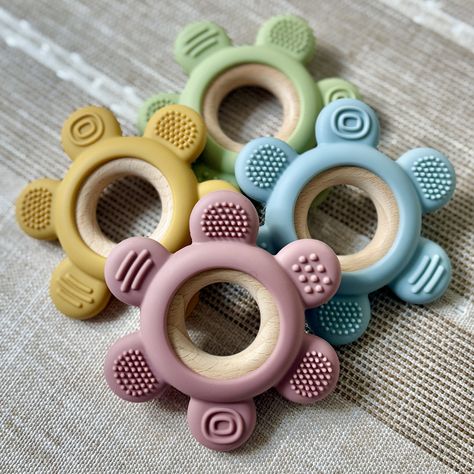 🌈 Our best-selling Textured Wooden & Silicone Teethers are back in stock... but not for long! These adorable teethers have been flying off the shelves, and it’s easy to see why! Made with natural wood and food-grade silicone, each teether is designed with gentle textures to soothe sore gums and keep little hands busy. Available in four lovely colors, they’re perfect for your little one or as a gift! Teether Toys, Silicone Teether, Back In Stock, Lovely Colors, Food Grade Silicone, Little One, Food Grade, Natural Wood, Gum