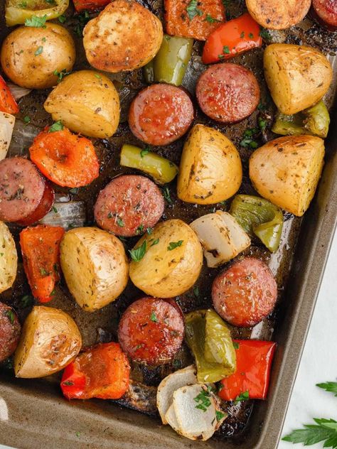 You'll love this easy Sheet Pan Sausage and Potatoes recipe! Sausage and baby gold potatoes bake on one pan with just 5 minutes of prep and easy cleanup! Sheet Pan Potatoes And Sausage, Sausage And Potatoes Bake, One Pan Sausage And Potatoes, One Sheet Pan Meals Sausage, Sheet Pan Sweet Potatoes And Sausage, Potatoes And Sausage Recipes, Pan Sausage Recipes, Sausage Bake One Pan, Kielbasa And Potatoes Sheet Pan