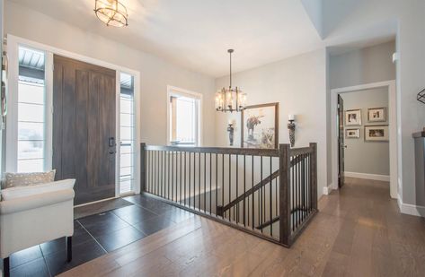 Open Downstairs Staircase, Open Concept Stairs To Basement, Entryway With Stairs To Basement, Door At Bottom Of Basement Stairs, Open Basement Stairs In Living Room, Stairs By Front Door, Open Stairs To Basement, Open Staircase To Basement, Closed Staircase