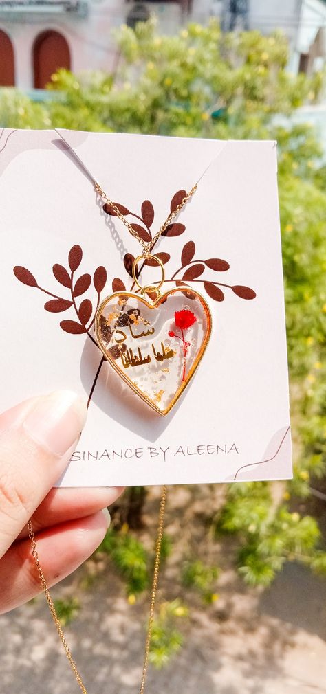 Heart-shaped resin pendant with names written on it. Resin Pendant Ideas, Resin Pendants, Name Pendent, Name Writing, Pendant Ideas, Resin Pendant, Resin Jewelry, Resin Art, Pendant