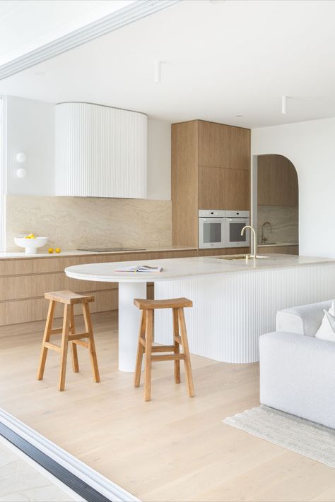 This kitchen features brushed brass tapware and a curved kitchen island, surrounded by wooden bar stools. Kitchen Island Inspiration, Curved Kitchen Island, Abi Interiors, Curved Kitchen, Island Bench, Bench Designs, Kitchen Island Design, Island Design, A Kitchen