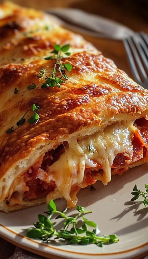 Packed with gooey mozzarella, savory pepperoni, and zesty Italian spices, this cheesy stromboli is the perfect shareable snack or casual dinner. Wrapped in golden, flaky dough, it's an easy-to-make recipe that delivers bold, satisfying flavors with every bite. Serve it hot for game nights or as a quick dinner option that everyone will love! Pepperoni Stromboli Recipe, Stromboli Recipe Pepperoni, Pepperoni Stromboli, Quick Dinner Options, Stromboli Recipe, Sausage Spaghetti, Italian Spices, Cheese Sausage, Gooey Cheese