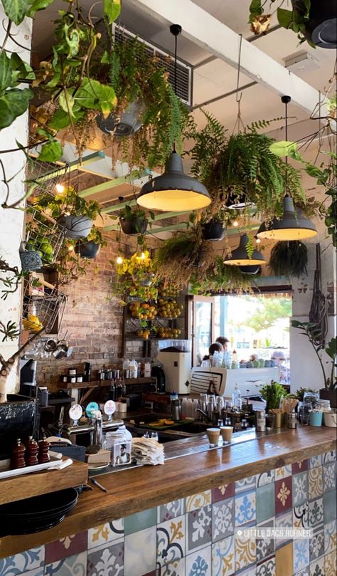 Cafe Floor Tiles Coffee Shop, Cozy Cafe Ideas Interior Design, Cottagecore Coffee Shop Aesthetic, Cafes With Plants, Plants In Cafe Interiors, Coffee Shop With Plants Interior Design, Hippy Cafe Coffee Shop, Inside Cafe Aesthetic, Restaurants With Plants