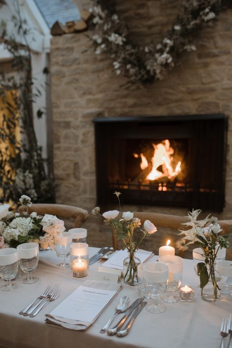 A fireplace glows beside a wedding table that is decorated in a festive manner Cosy Winter Wedding, Winter Wedding Uk, Cosy Wedding, Daylesford Farm, Wedding Feast, Green Weddings, Christmas Farm, Cosy Winter, Winter Love