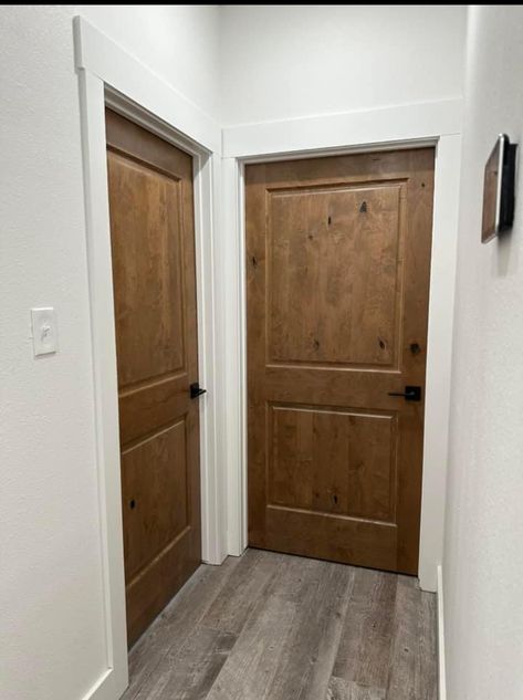 Wood Door White Trim Interior, White Trim With Dark Wood Doors, Wood Trim And White Doors, Farmhouse Doors And Trim, Knotty Pine Doors With White Trim, Dark Wood Doors With White Trim, Dark Wood Trim Bathroom, White Trim With Stained Doors, White Trim Stained Doors