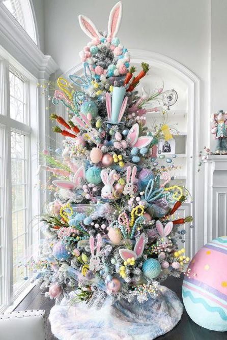 This Easter tree is an explosion of color. Dress up a flocked artificial tree for spring by tucking faux egg branches and pastel beads into the boughs. Add a few stuffed bunnies, pastel ornaments, and paper carrots for a colorful mix. #eastertree #eastertreeideas #easterdecorations #bhg Branches Vase, Easter Tree Ideas, Easter Tree Diy, Diy Tree Decor, Easter Tree Ornaments, Easter Egg Tree, Easter Craft Decorations, Easter Tree Decorations, Spring Decoration