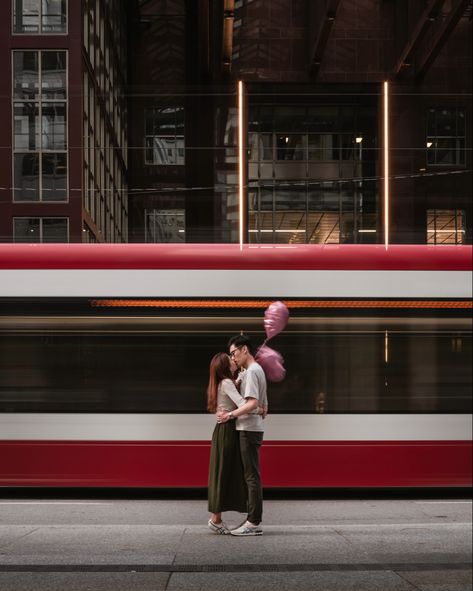 Creative engagement shoot in front of TTC streetcar in the streets of downtown Toronto. #Heartshapedballoons #Aesthetic #Artistic #Engagementshootposes #engagementshoot #torontophotographer #engagementposes #weddingphotography #torontophotography Downtown Toronto Wedding Photos, Toronto Engagement Photoshoot, Toronto Street Photography, Toronto Engagement Shoot, Ttc Streetcar, Toronto Engagement Photos, Cozy Photoshoot, Toronto Couple, Couples Downtown