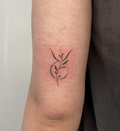 Taurus zodiac symbol tattoo on the outer arm May Taurus Tattoo, Taurus Birth Flower Tattoo, Taurus Sagittarius Tattoo, Taurus Minimalist Tattoo For Women, Taurus Wrist Tattoo, Dainty Taurus Tattoo For Women, Tattoo Zodiac Taurus, Simple Taurus Tattoo For Women, Taurus Sun Tattoo