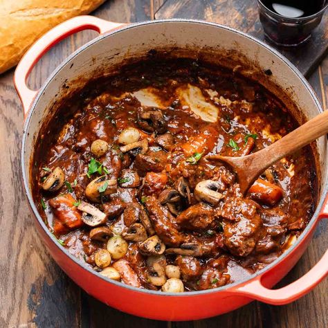 Beef bourguignon is a classic comforting French stew that combines chunks of beef braised until tender in a red wine broth with carrots, onion, and herbs, and topped with sauteed mushrooms and pearl onions. French Stew, Cabbage Steak, Pizza Sides, Sip And Feast, Pearl Onions, Beef Roast, Savory Food, Mushroom And Onions, Homemade Beef