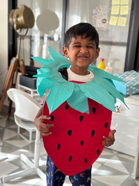 A red coloured cardboard strawberry costume mounted on a 5 year old boy Strawberry Fancy Dress, Strawberry Costume Diy, Strawberry Costume, Cardboard Costume, Fancy Dress Costume, Costume Diy, Kids Diy, Diy Cardboard, Dress Costume