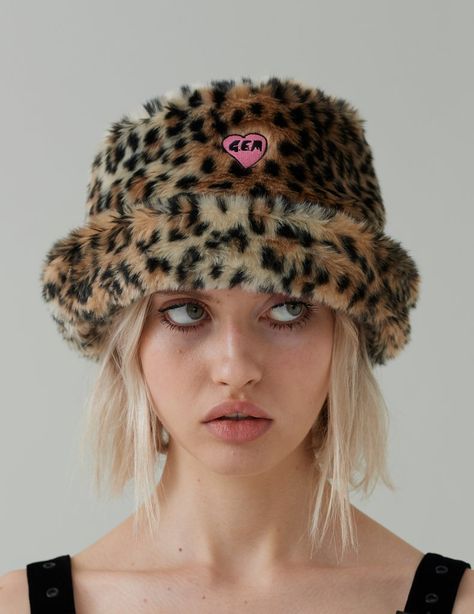 Faux fur bucket hat Leopard print G.E.M heart embroidery Satin lined Spot clean only 100% Polyester Available in O/S G.E.M is the new venture label created by founder and creative director of Lazy Oaf, Gemma Shiel. “Inspired by iconic females like Bjork, Madonna, Cyndi Lauper and female punk scene icons (plus an unhe Fur Hats For Women, Leopard Hat Outfit, Lazy Oaf Aesthetic, Leopard Bucket Hat Outfit, Trendy Leopard Print Cap, Female Punk, Scene Icons, Outfit With Hat, Leopard Accessories