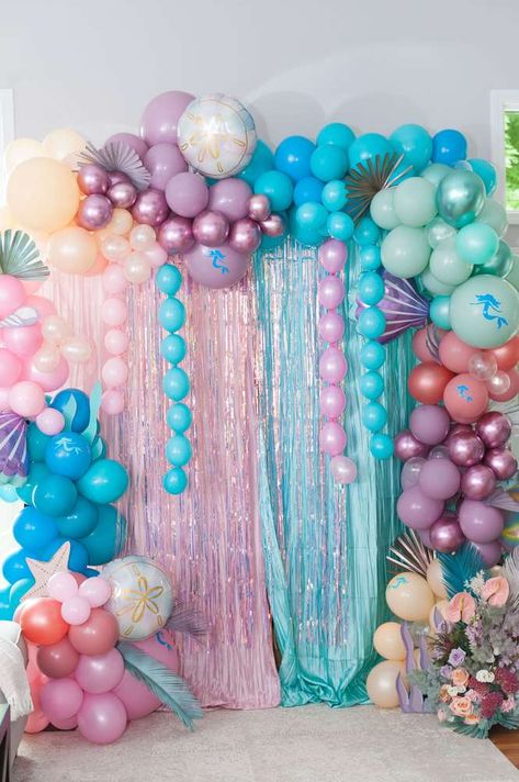 Sophia's Magical Mermaid 4th Birthday Pool Party | CatchMyParty.com Mermaid Birthday Party Balloon Arch, Mermaid Party Photo Backdrop, Dive Into 5 Mermaid Party, Infinity Decorations, Mermaid Backdrop Ideas, Mermaid Barbie Birthday Party, Mermaid Pool Party Ideas, Barbie Mermaid Birthday Party, Little Mermaid Pool Party