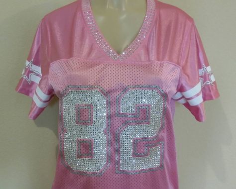 **Please read all details on custom blinged jerseys before purchase *My services include design, crystals, and labor only* - Women's Nike NFL jersey full bling: $249.99 ** Any jerseys with the #88, #86, #89 will be a $29.99 additional fee due to extra labor hours and crystal cost. **Customer must provide jersey, all jersey are shipped to my address** - Message me for my address - Jerseys feature over 2000-3000+ Swarovski Crystals - I spend 5-8 hrs hand setting every crystal to the jersey Process Jersey Shore Style, Bedazzled Outfit, Pink Out Outfit Ideas, Pink Bling Clothes, Diy Jersey, Pink Jersey Top For Game Day, Bling Outfits, Bedazzled Football Jersey, Jersey Fits