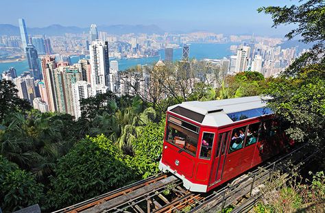 Arguably Hong Kong’s most famous attraction, Victoria Peak rises 1,805 feet above sea level and overlooks Central and the city beyond. Reaching the top requires a seven-minute ride on the Peak Tram, the world’s steepest funicular railway. On clear days you can see Kowloon’s eight mountains, but the nighttime views of both sides of the harbor illuminated is equally stunning. Hong Kong Travel Guide, Hong Kong Island, Victoria Harbour, Hong Kong Travel, The Peak, Culture Travel, Tour Packages, Macau, Kuala Lumpur