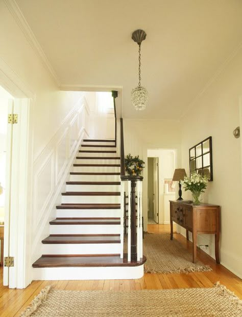 Grand Staircase in New York Colonial Home. painted staircase, entryway, foyer, pendant light, wood floors Colonial Style Staircase, Staircase In Entryway, Colonial Home Entryway, Colonial Flooring, Colonial Staircase Ideas, Side Staircase Ideas, Center Colonial Entryway, Colonial Entryway Foyers, Hardwood Floor Stair Landing