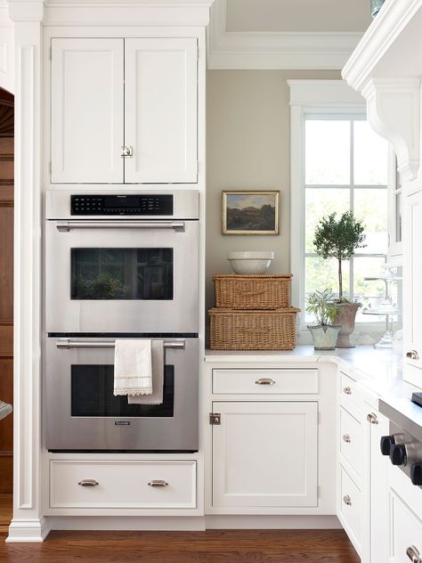 Typically stacked and built directly into perimeter cabinetry, double ovens provide a sleek look and added convenience. This kitchen feature offers a main oven you can use without bending over and a secondary oven for plate warming and additional baking. #kitchenideas #kitchenremodel #kitchenplanningideas #kitchenmakeover #bhg Wall Oven Kitchen, Outdoor Kitchen Countertops, Kitchen Decor Themes, Kitchen Designs Layout, Kitchen Design Trends, Kitchen Farmhouse, Smart Kitchen, Kitchen Trends, Double Oven