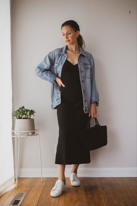 Ashley wearing a black slip dress, light Wash denim jacket, white sneakers, tortoise shell sunglasses and a black woven handbag Skirts With Jackets Outfit, Long Dress Denim Jacket, Dress With Oversized Denim Jacket, Black Dress With Jeans Jacket, Satin Dress With Denim Jacket, Black Dress And Denim Jacket Outfit, Oversized Denim Jacket With Dress, Dress With Oversized Jacket, Denim Jacket With Black Dress