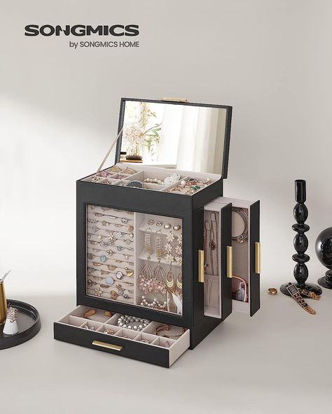 The position of the 3 side drawers can be changed to allow you to have different jewels on display as you wish. And your valuables are kept dust-free behind the clear glass window of this jewellery box!

3 side drawers for hanging your necklaces and pendant earrings to avoid tangling and for storing rings, stud earrings, bracelets, or watches; the top tray and the bottom drawer offer storage for brooches, hair pins, or other accessories Portable Jewelry Organizer, Side Drawers, Luxury Jewelry Box, Big Mirror, Hanging Necklaces, Travel Jewelry Box, Jewelry Organizer Box, Vertical Storage, Large Mirror