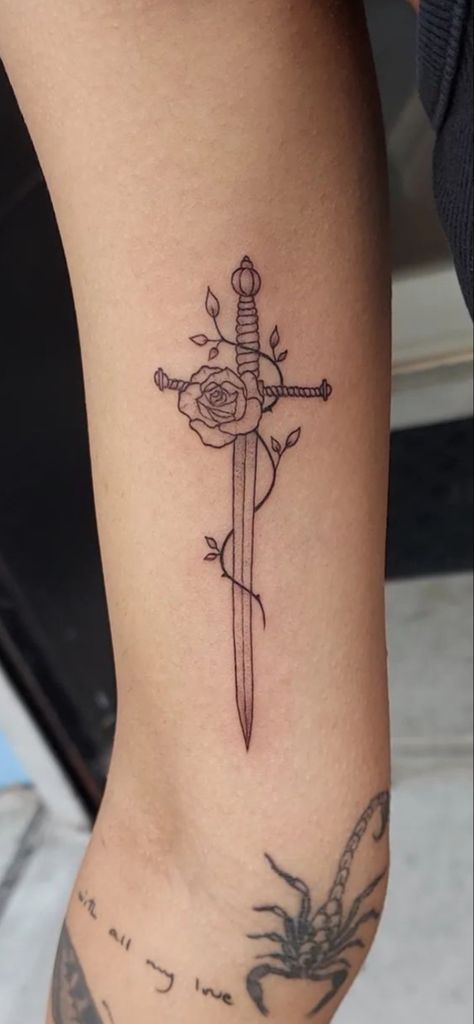 Rose With Swords Tattoo, Spine Dagger Tattoo, Girly Dagger Tattoo, Dagger Sternum Tattoo Women, Irish Rose Tattoo, Dagger And Flower Tattoo, Dagger Thigh Tattoo, Dager Tattoos For Women, Tiny Dagger Tattoo