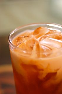 ~Thai Iced Tea~ Bring 6c of water, 1/2c sugar, 5 star anise, 2 cinnamon sticks, 1/4 tsp ground tamarind to a boil. Take off heat, let 8 bags black tea (or 6bags black tea & 2 bags rooibos) steep for 1 hour at room temp. Tea should be very strong, it gets diluted. Remove bags, anise & sticks. Whisk in 1/2c sweetened condensed milk and vanilla to taste. Refrigerate. Fill glass with ice & 3/4 full with tea. Top off with coconut milk, don't stir. Add chocolate mint as garnish. Tai Tea, Thai Tea Recipe, Thai Tea Recipes, Thai Iced Tea, Tasty Thai, Thai Tea, Half And Half, Tea Recipe, Drinks Smoothies