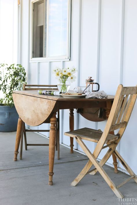 Secondhand wood bistro set with drop leaf table on porch. Porch Bistro Set, Small Front Porch Seating, Porch Seating, Front Porch Seating, Front Porch Decorating Ideas, Affordable Outdoor Furniture, Building A Pole Barn, Porch Decorating Ideas, Porch Posts