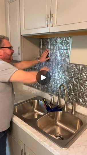 Showing how to apply facade faux tin tile backsplash | tile | Join John and I as we show you how to apply a facade faux tin tile backsplash. | By The Crafty DecoratorFacebook Facade Backsplash Kitchen, Tin Tile Backsplash Kitchen, Ceiling Tile Backsplash, Tin Ceiling Backsplash, Tin Tile Backsplash, Crafty Decorator, Tin Backsplash Kitchen, Faux Tin Tiles, Metal Tile Backsplash