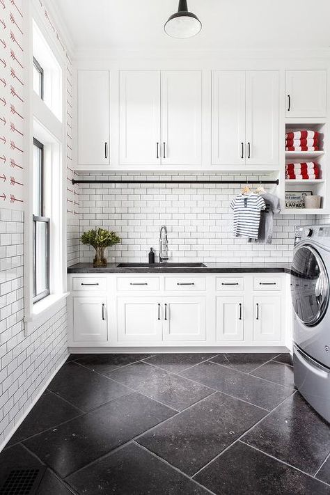 Large cottage laundry room designed with a black and white theme starting with large black herringbone floor tiles. Black Kitchen Floor Tiles, Bulthaup Kitchen, White Laundry Rooms, Interior Simple, Dream Laundry Room, White Subway Tile Backsplash, White Laundry, Farmhouse Laundry Room, Laundry Room Cabinets