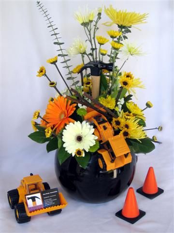 centerpiece with construction fillers/accents Tool Centerpieces, Construction Centerpieces Table Decorations, Construction Birthday Centerpieces Diy, Construction Centerpieces, Tonka Truck Centerpieces, Excavator Birthday Party Centerpieces, Gala Centerpieces, Grocery Store Flowers, Tools Theme