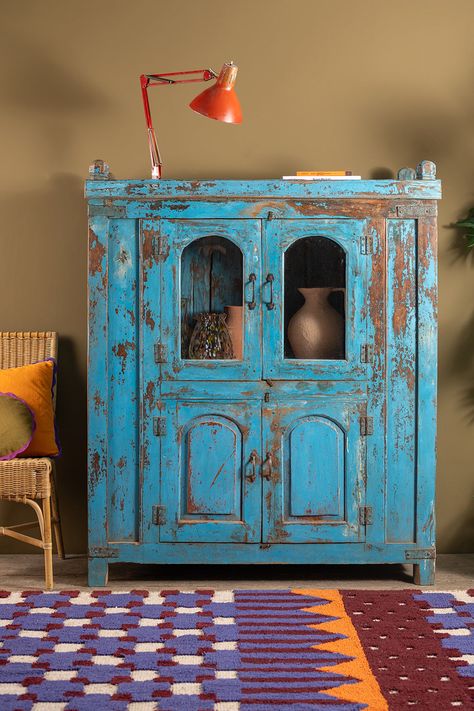 Our vintage blue wooden cabinet features two doors at the bottom and two doors at the top with arch topped windows. The four doors open onto generous cupboard space that is well suited to both storage and display. Distressed blue paintwork, subtle panelling and finials work together to create a characterful and stately piece of furniture. Small Storage Cabinet Old, Carved Wooden Cabinet, Gothic Furniture Storage Cabinets, Vintage Wooden Wardrobe, Vintage Wooden Cupboard, Vintage Chest Trunk, Vintage Shelving, Wooden Printing Blocks, Vintage Mirror Wall