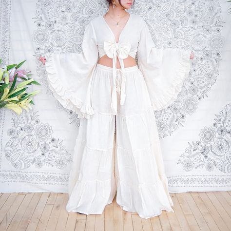 Flow freely in boho bliss with these wide-leg tiered pants and ruffle-sleeve top ensemble 🌸✨ https://karmanepalcrafts.com/products/flowy-tiered-pants #bohohippiechic #widelegpants #flowy #flarepants #bohemianstyle #plussizefashion #ootdfashion #springfashion #summeriscoming Flowy Chiffon Bottoms With Ruffles, Flirty Ruffle Hem Flowy Bottoms, Cream Ruffled Flowy Bottoms, Chic Flare Pants With Ruffles, Bohemian Wide-leg Pants With Ruffles, Boho Hippie Chic, Summer Is Coming, Ruffled Sleeve Top, Ootd Fashion