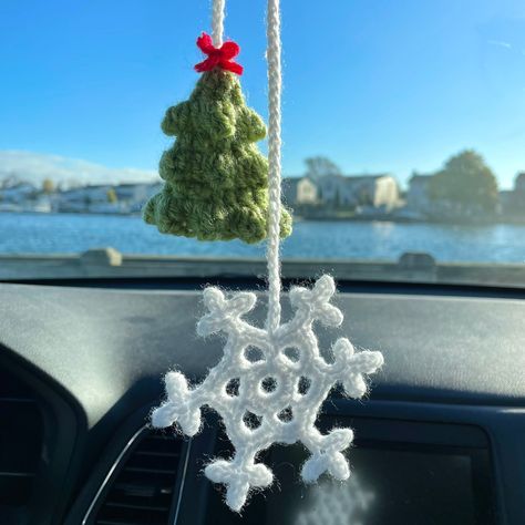 For all Christmas/winter/holiday season lovers!! These Christmas tree and snowflake hanging accessories are perfect decoration for your tree or even as a car mirror accessory! 🎄❄️ These are handcrafted with so much love and care, and are made in a loving, non-smoking home! YOUR PURCHASE INCLUDES: One crochet Christmas tree and snowflake car accessory! MEASUREMENTS: The tree measures approximately 2 inches tall, and the snowflake measures approximately 1.5 inches tall! Tiny and sweet for displaying as a decoration on your car mirror!  MATERIALS:  ➖100% acrylic yarn CARE INSTRUCTIONS:  ➖Recommended to spot clean with water and mild soap, if needed! ➖Treat with gentle care! Even though the parts are securely fastened, rough treatment may cause them to loosen. DISCLAIMER: ➖It could pose a cho Christmas Crochet Car Accessories, Crochet Christmas Hanging Decorations, Crochet Car Accessories Christmas, Christmas Tree Crochet Decorations, Crochet Car Mirror Hanging Christmas, Crochet Winter Decoration, Winter Crochet Decor, Christmas Car Accessories, Crochet Car Hanging Pattern Free