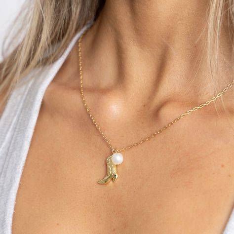 Complete your cowgirl look with a twist! Our Boot N' Pearl Necklace features a genuine cowboy boot charm alongside a lustrous pearl, making it a playful and unique addition to any outfit. Yee-haw! 18k Gold Plated over Stainless Steel 18" + 2" Ext Water & Tarnish Resistant Hypoallergenic Cowgirl Look, Yee Haw, Cowboy Boot, Original Gift, Cz Stone, Womens Jewelry Necklace, Cowboy Boots, Pearl Necklace, 18k Gold