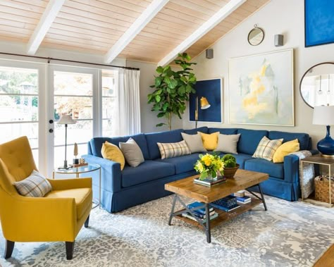 bright living room // blue and yellow decor // blue sectional sofa // slanted ceiling Blue And Yellow Living Room, Blue Couch Living, Blue Sofa Living, Blue Sofas Living Room, Blue Couch Living Room, Furnitur Ruang Keluarga, Blue Living Room Decor, Blue Couches, Yellow Living Room