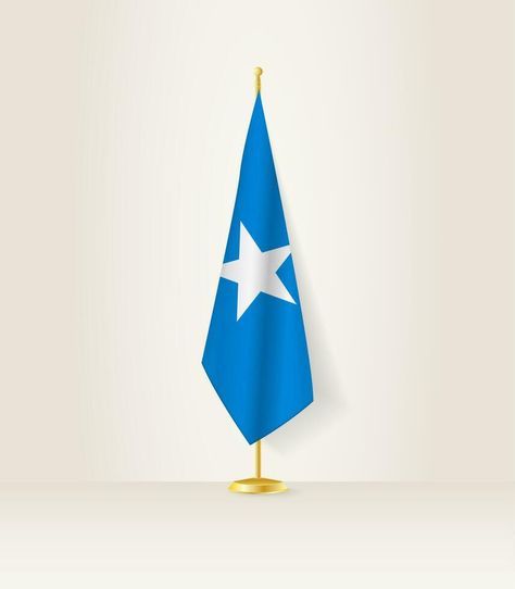 Somalia flag on a flag stand. Soomaali Flag, Somalia Flag Wallpaper, Somali Flag Wallpaper, Somali Flag, Somalia Flag, Stitch Drawings, Peaky Blinders Poster, Cracked Wallpaper, Independence Day Flag