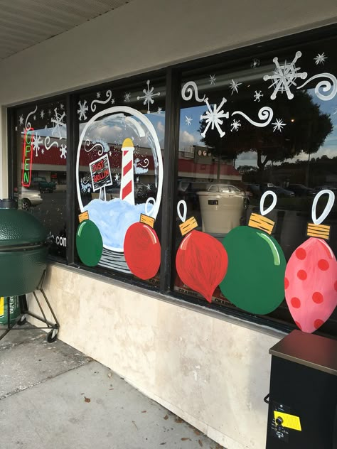 Christmas retail window display with ornaments and a snow globe Glass Door Christmas Decor, Window Painting Ideas, December Decorations, Windows Painting, Diy Christmas Window, Christmas Library, Easy Holiday Decorations, Christmas Desk, Painted Window Art