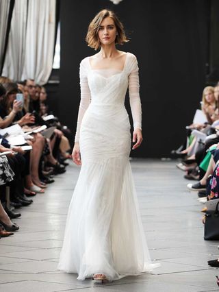 Amsale Spring 2019 Collection tulle fit and flare wedding dress with hand pleated bodice ruched sleeves and corded lace applique Ruched Lace Wedding Dress, Wedding Dresses With Sleeves Fit And Flare, Tulle Wedding Sleeves, Fit And Flare Wedding Dress With Sleeves, Sheath Wedding Dress With Sleeves, Tulle Wedding Dress With Sleeves, Pleated Wedding Dress, Amsale Wedding Dress, Ruched Wedding Dress