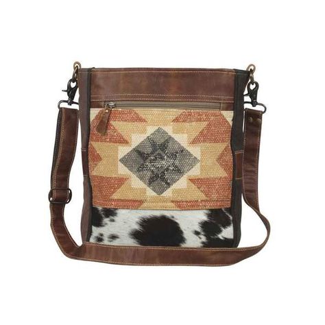 The Enchanting Shoulder Bag showcases an impeccable blend of rug, hair-on leather and an old military tent. The sober look enhances the persona of the user and keeps her systematized all the time. Environmentally responsible manufacturing using upcycled canvas, rug, and leather. Up-cycled canvas, rug, and leather using natural vegetable tanning process.   #bohochic #bohochicbag #HarleyButler #HarleyButlerTC Canvas Rug, Western Purses, Custom Strap, Gift Boutique, Leather Shops, Engraved Items, Aztec Print, Cross Body Bag, Body Bag