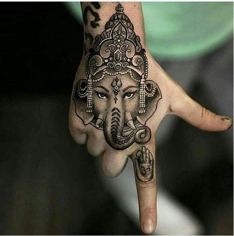 23. Indian lucky charm on the hand This distinctive piece of art on the hand shows an ornate elephant with a traditional Indian sign on its forehead, the icon of a hand on the forefinger is an amusing detail. The tattooing is about a true sense of mindfulness. - source Elephant Tattoo On Hand, Hand Tattoo Men, Ganesha Tattoos, Indian Elephant Tattoo, Cute Elephant Tattoo, Hindu Tattoos, Ganesh Tattoo, Tato Tradisional, Polynesian Tattoos