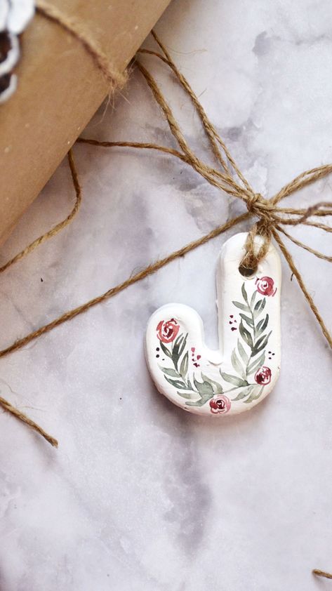 Hand painted clay initial letter ornament. Pine branches painted with watercolor by Sam Allen Creates.