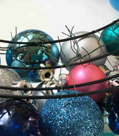 DIY Christmas Wreath with Ball Ornaments - FiberArtsy.com Ball Ornaments Diy Christmas, Christmas Balls Wreath Diy, Ball Ornaments Diy, Tie Angels, Diy Christmas Ornament Wreath, Ornament Wreath Diy, Christmas Ball Ornaments Diy, Decorative Mesh Wreaths, Lantern Crafts